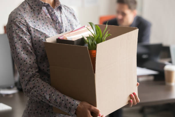Close up view of new female employee intern holding box Close up view of new female employee intern holding cardboard box with belongings start finish job in company office, busnesswoman newcomer worker get hired fired on first last day at work concept quitting a job stock pictures, royalty-free photos & images