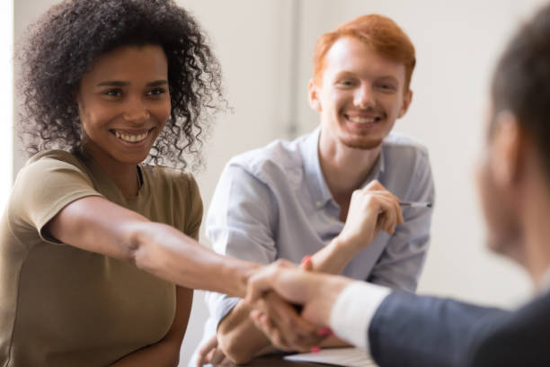 istock Happy african hr handshake candidate at team meeting job interview 1139873821