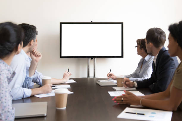 istock Business people group sitting at conference table looking at screen 1139873825