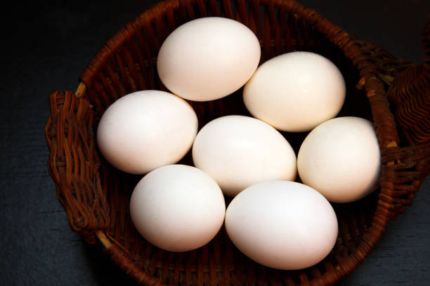istock White chicken eggs in a wicker basket - top view close. 1139873879