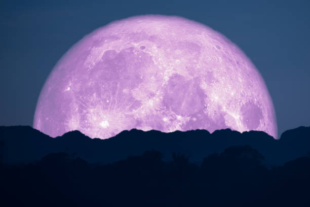 istock super full pink moon back on silhouette mountain on night sky 1139874024