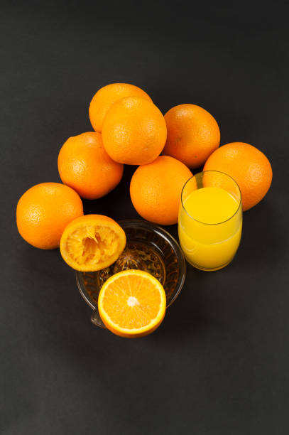 istock orange on dark with manual juicer 1139874164