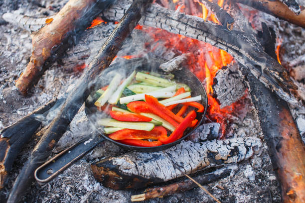 istock Cooking dishes from red bell peppers and cucumbers in a pan on a fire 1139874517