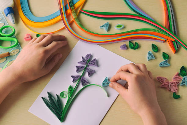 istock Quilling technique. Making decorations or greeting card. Paper strips, flower, scissors. Handmade crafts on holiday: Birthday, Mother's or Father's Day, March 8, Wedding. Children's DIY concept. 1139875821