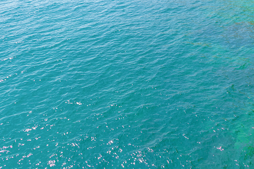 Azure-turquoise surface of a calm sea, background.