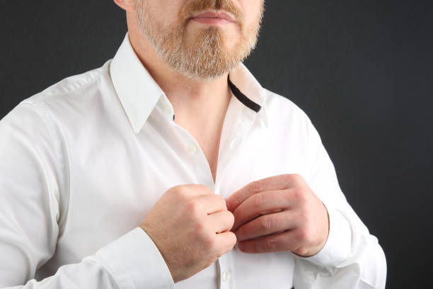 istock man fastens buttons on his shirt 1139878441