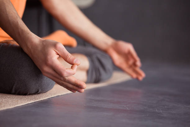 istock Man practicing yoga against a blue wall background 1139878444