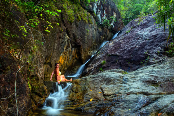 istock Woman bathes in a Waterfall 1139879894