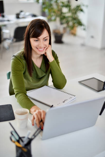 istock Woman using laptop in modern office. 1139880089
