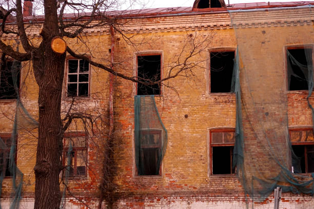 istock Empty destroyed building with broken windows. Pink sky Sunset. Photo in red colors. The oppressive atmosphere of destruction. Scenery for a horror movie 1139880280