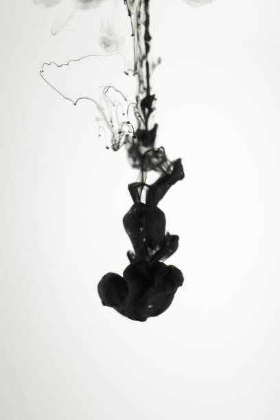 istock Black paint ink in water on white background 1139881600