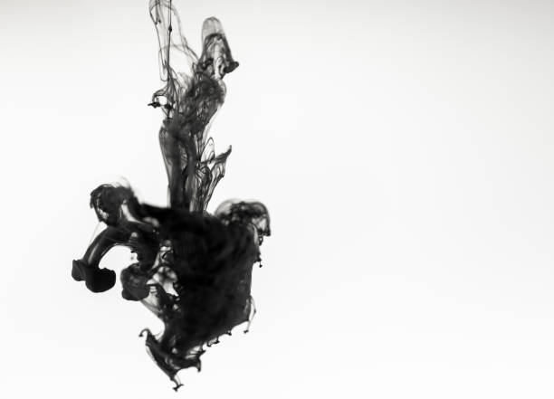 istock Black paint ink in water on white background 1139881614