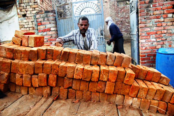 Men loading bricks in the horse cart.