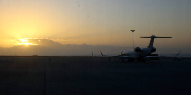 istock silhouette of airliner at sunset 1139884214