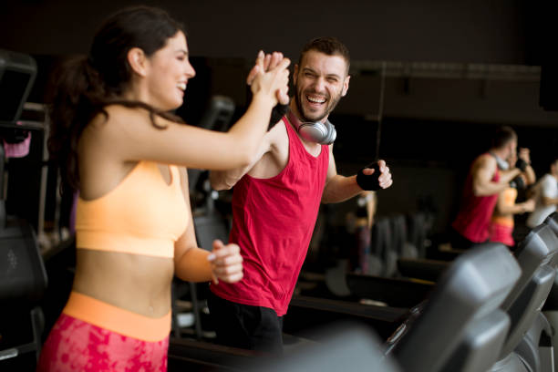 istock Young couple running on treadmills in modern gym 1139884249