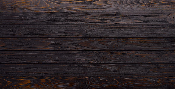 Dark wooden planks table background top view