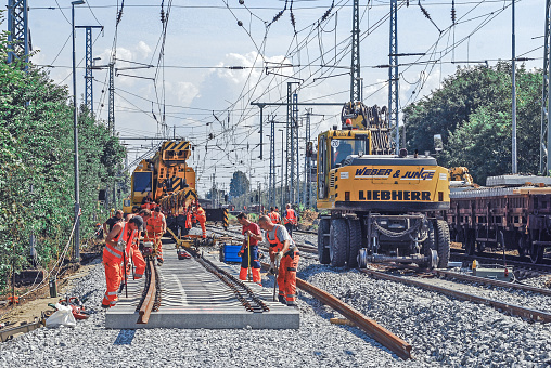 Eilenburg, Germany, July 27, 2011 - Construction worker laying tracks on a construction site near Eilenburg in Saxony.