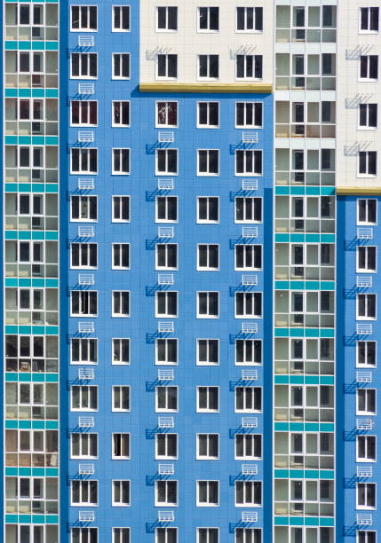 istock High-rise wall with windows. Multi-storey building. Blue house background with windows 1139885657