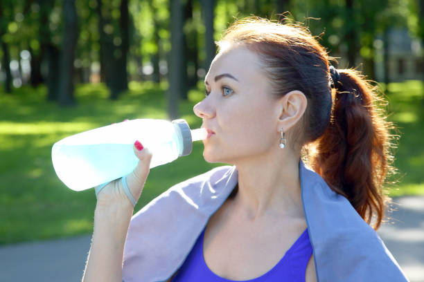 istock young sporty girl drinking water from a bottle 1139886861