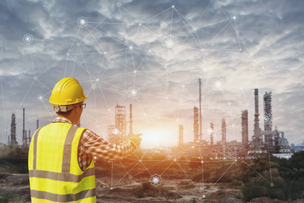 istock Businessman in safety helmet touching virtual interface screen . 1139886892