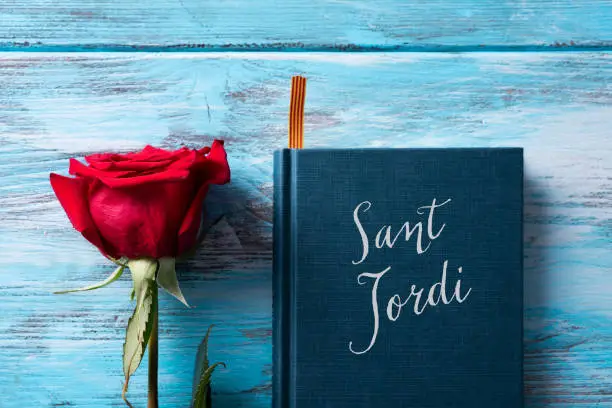 Photo of rose, catalan flag, book and text Sant Jordi