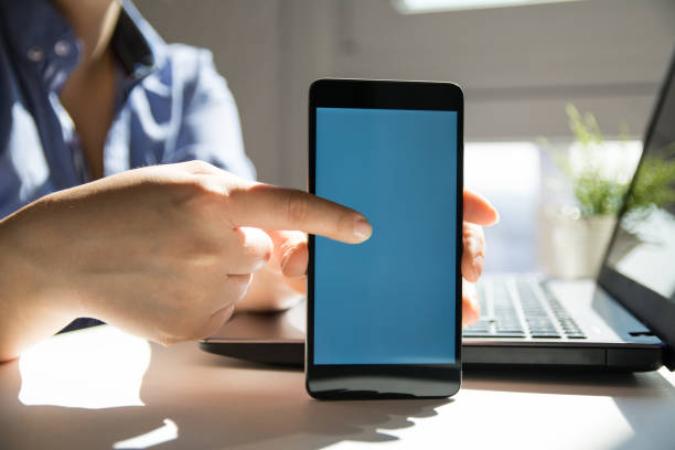 istock Close up of woman's hands using smart phone touchscreen 1139889848
