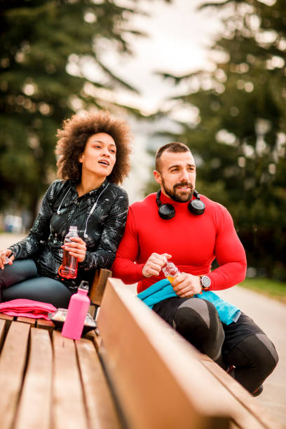 istock Two young athletes hydrating themselves while taking a break after exercising in a city park 1139890833