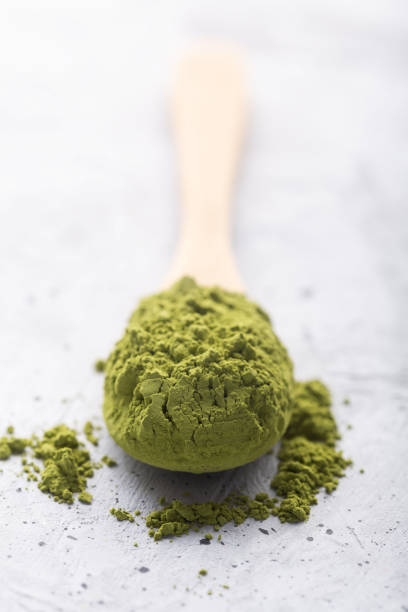 istock Green tea matcha in a spoon on concrete surface. Close up shot 1139893945