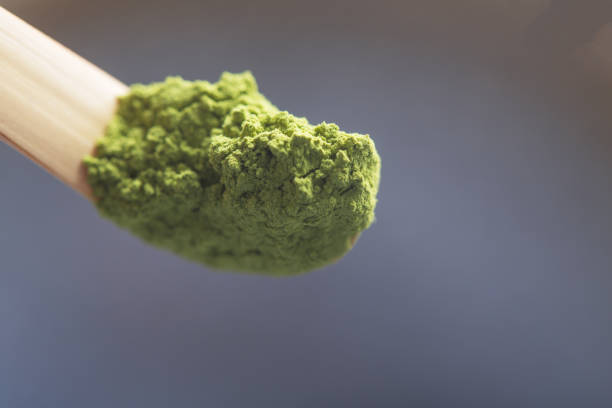 istock Green tea matcha in a spoon on a dark surface. Close up shot 1139894190