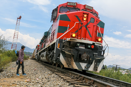 Coahuila, Mexico, Jul 26 - A migrant of Central American origin waits on the railway line to get on a container train, known as 'The Beast', to go to the border of the United States and Mexico, between the states of Coahuila (Mexico) and Texas (USA).