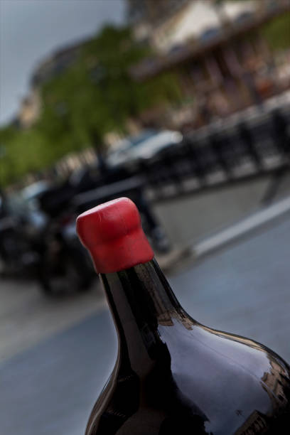 Close up of a red wine bottle in front of a winery in Bordeaux city France