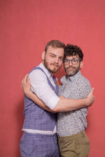 istock two men, gay couple portrait in studio, looking to camera. 1139897164