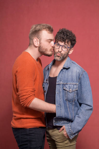 istock two men, gay couple making a face while being other. 1139897867