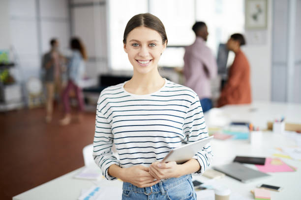 istock Contemporary Young Woman Posing in Office 1139897906