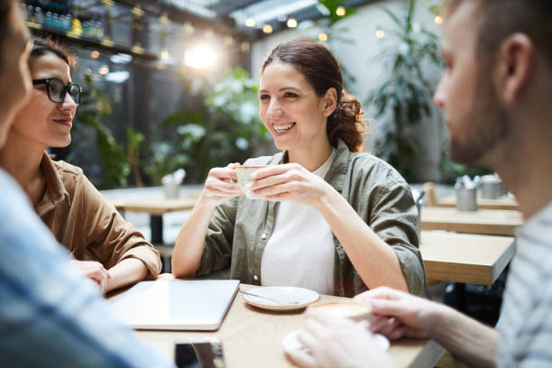 istock Happy friends drinking coffee in cafe 1139898975