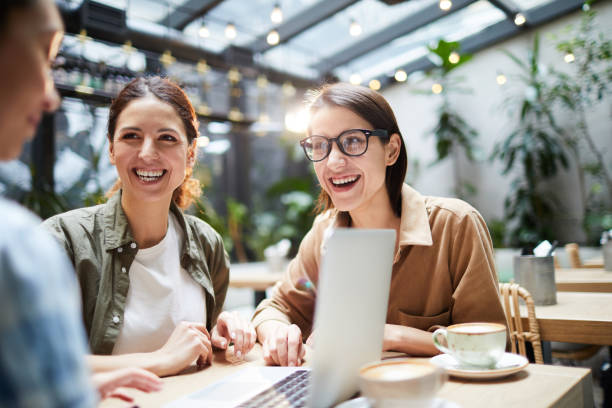 istock Excited colleagues working as team in cafe 1139899042
