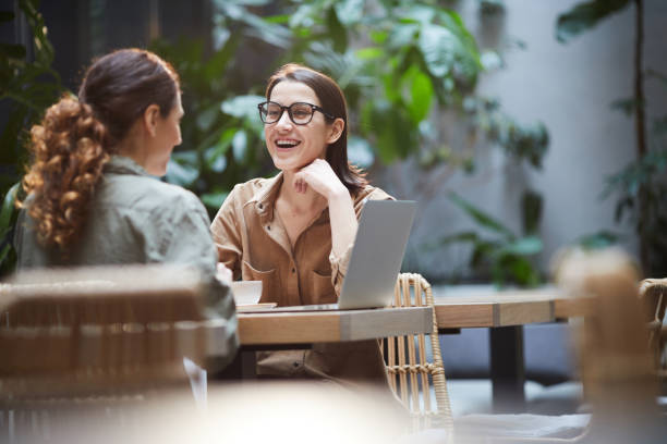 istock Woman laughing during lunch with colleague 1139899091