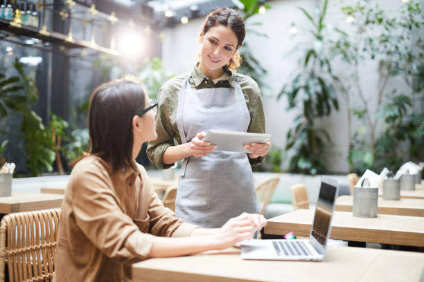 istock Waitress asking guest about food and drink preferences 1139899129