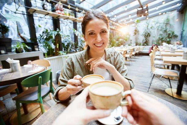 istock Happy girl drinking matcha tea with friend 1139899235