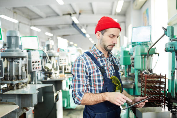 istock Mature Factory Worker Using Tablet by Machines 1139899637