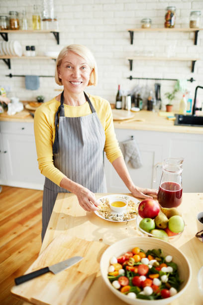 istock Happy woman in modern kitchen 1139901525