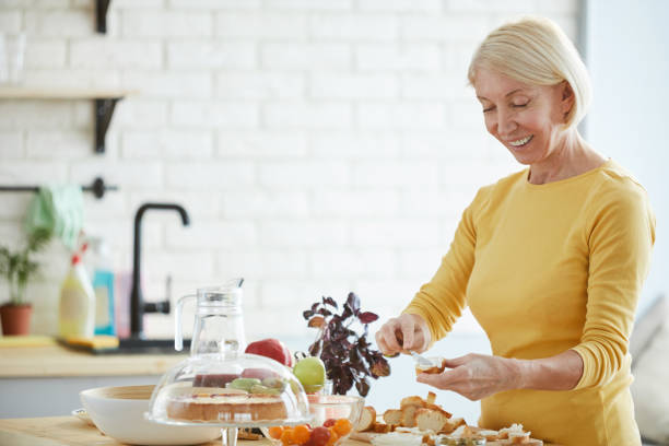 istock Positive woman preparing bruschetta in kitchen 1139901535