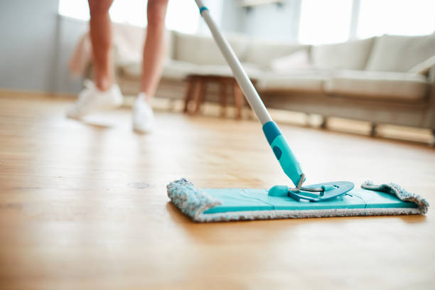 Cleaning parquet floor Close-up of unrecognizable woman using mop with microfiber pad while cleaning parquet floor in living room mop photos stock pictures, royalty-free photos & images