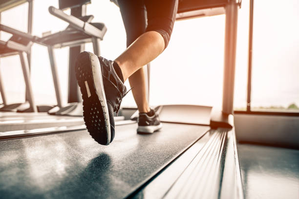 Close up on shoe,Women running in a gym on a treadmill.exercising concept.fitness and healthy lifestyle stock photo