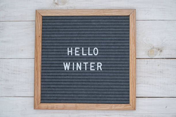 istock text Hello winter on wooden letter Board in white letters on grey background 1139903233