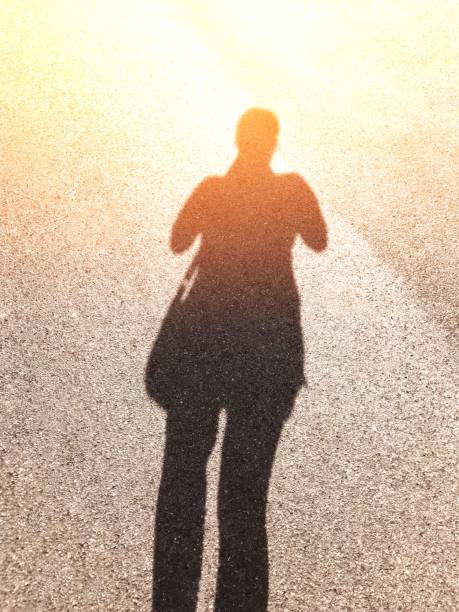 istock Woman traveler shadow with orange light effect 1139903412