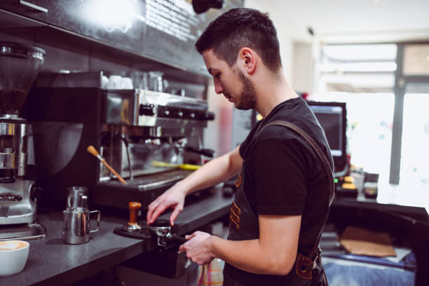 istock Male Waiter Making Coffee On Machine 1139903528