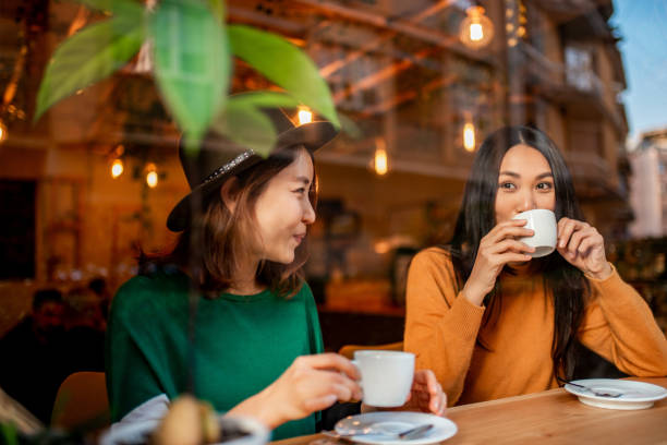 istock Two Asian girls having a coffee. 1139903755