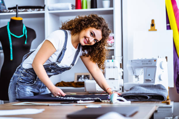 istock The beautiful woman sews clothes on the table 1139905412