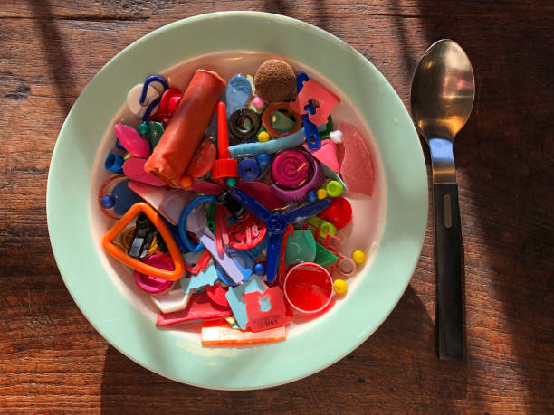 Plate of plastic soup on a table with a spoon